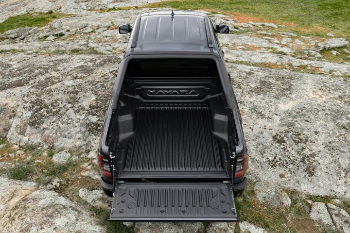 2026 Nissan Navara PRO-4X finished in Boulder Grey captured from above with the open tub, lowered tailgate and full bed liner visible.