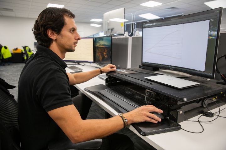 A Engineer sits at a computer used to design components