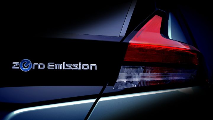 Close-up of the rear tail light and "zero emission" logo on a modern electric car.
