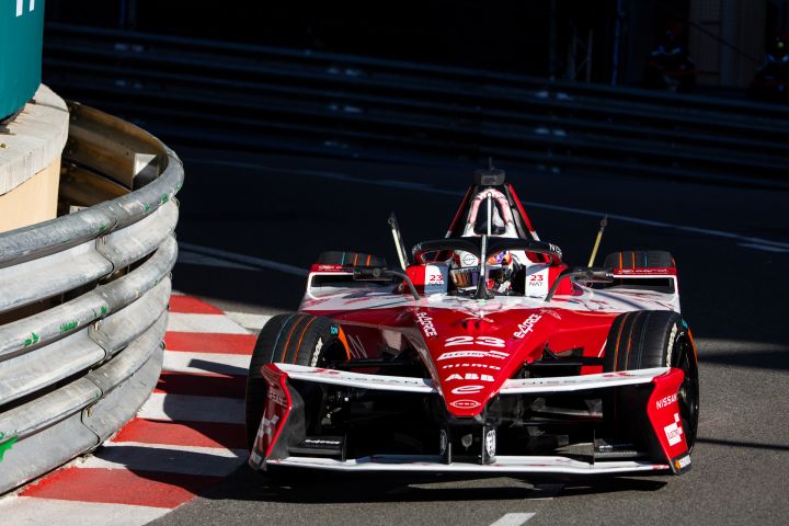 Front on shot of Norman Nato in the #23 car turning right into a corner with a barrier visible on the left hand side of the photo.