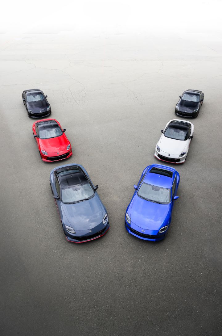 An aerial view of a group of Nissan vehicles in a V formation.