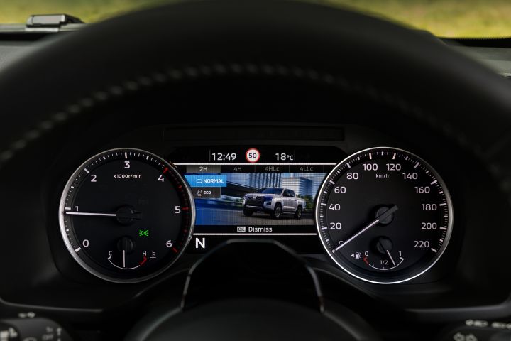 Instrument binnacle view in a 2026 Nissan Navara ST‑X showing the 7-inch TFT Display Instrument Cluster with a terrain-mode display, a vehicle illustration, and selectable drive modes listed along the left side.