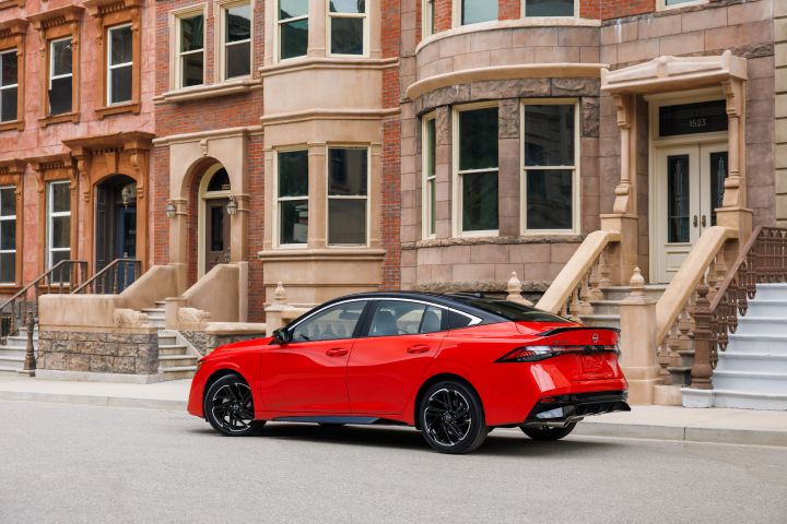 Left profile view of the 2026 Nissan Sentra parked in front of city town homes.