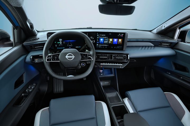 Driver pov of full dashboard cockpit showing steering wheel, driver focused infotainment, rear view mirror, front seats and side mirrors