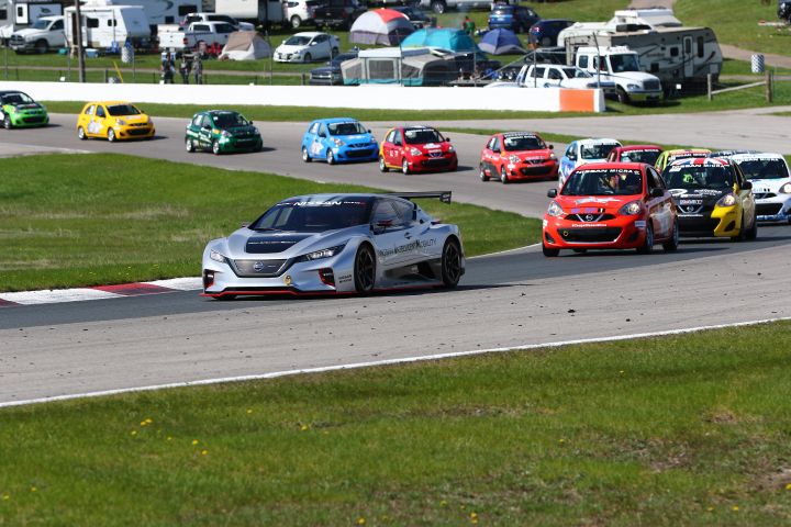 Several Nissan Micra being lead by the Nissan LEAF RC
