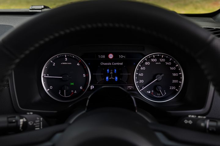 Driver’s view of the 7-inch TFT Display Instrument Cluster in a 2026 Nissan Navara ST-X, showing the Chassis Control screen between the analogue tachometer and speedometer.