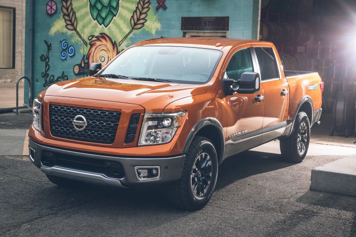 A orange 2019 Nissan TITAN Pro4X parked near a mural