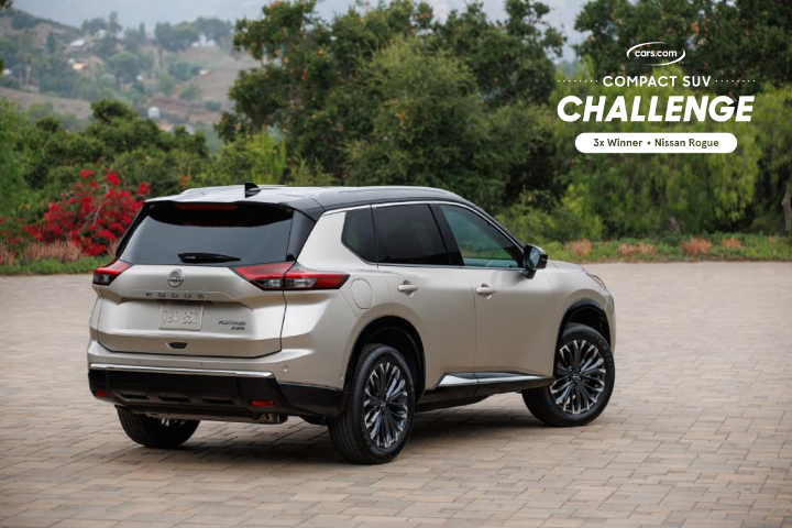 Right rear ¾ angle of the 2024 Nissan Rogue parked on a brick drive with trees behind.