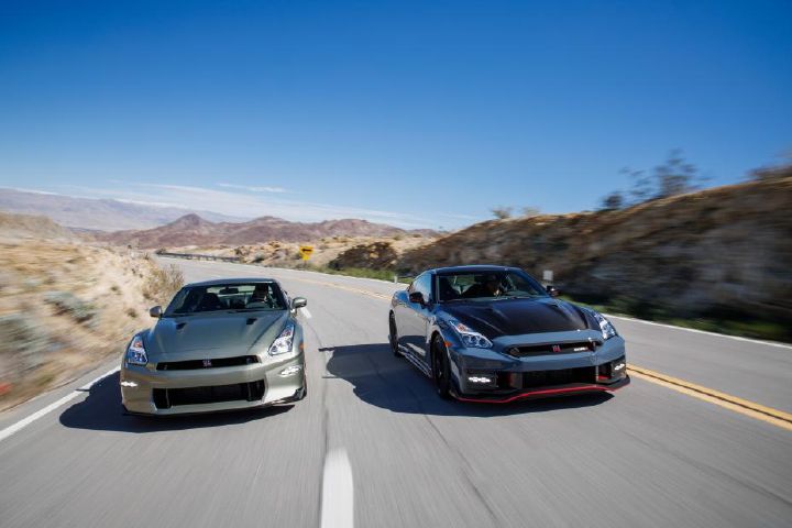 A 2024 Nissan GT‑R NISMO and GT‑R T-spec driving down the road.