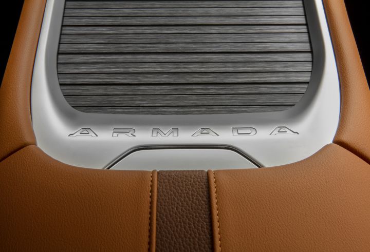 The tan leather center console and accordion cover with Armada written on the lower half inside the 2025 Nissan Armada.
