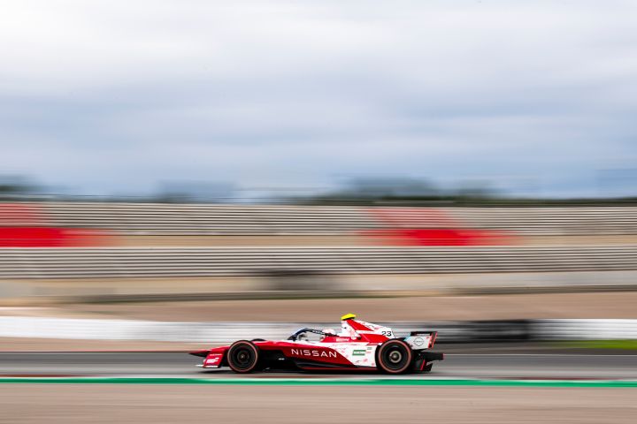 Side on shot of Norman Nato in the #23 car with the rest of the image blurred as the car is the focus of the image.