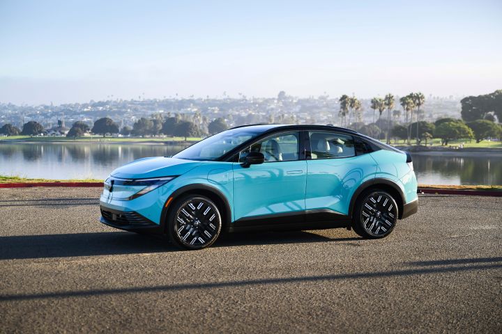 Left profile view of the 2026 Nissan LEAF parked on asphalt infront of water.