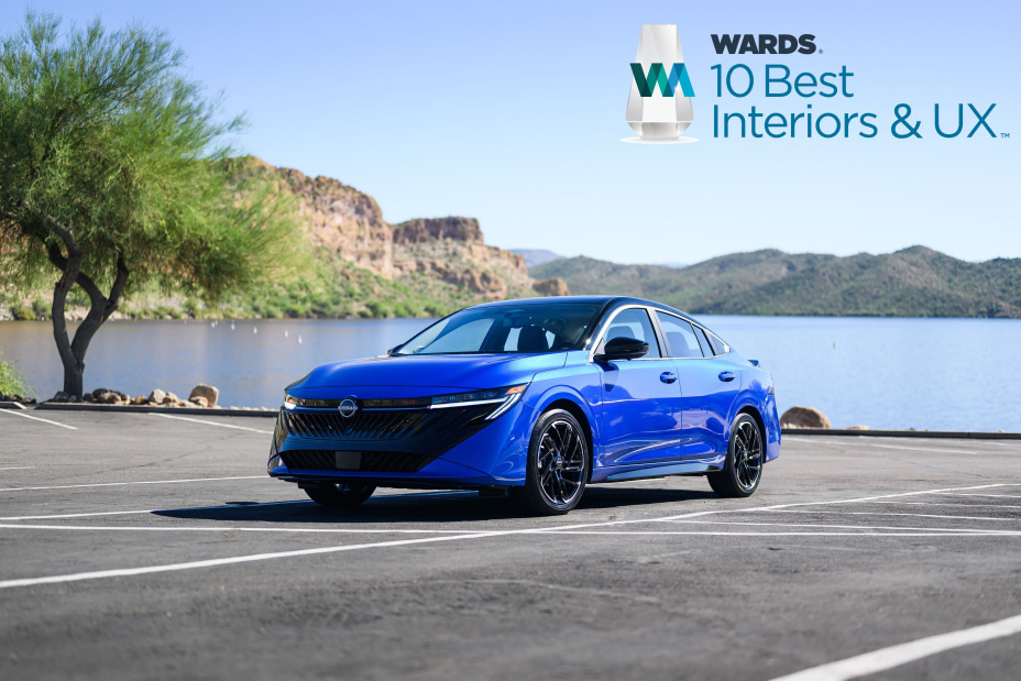 Blue Nissan Sentra on a ¾ angle in front of a waterfront.
