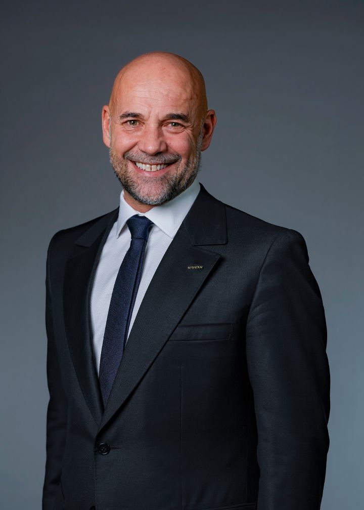 Portrait of Guillaume Cartier (suit, tie and NISSAN corporate pin)
