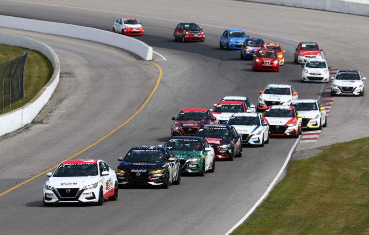 Group of Nissan Sentra cup cars driving on the track.