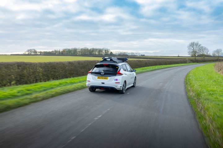 Rear dynamic shot of evolvAD on rural route on single lane