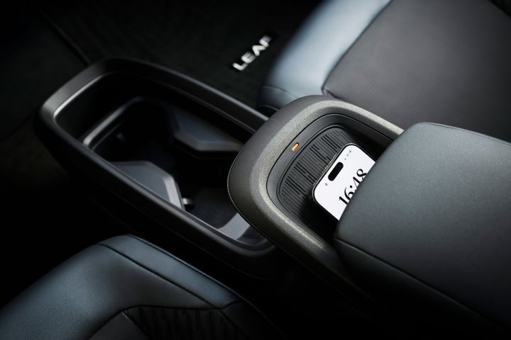 The canter console featuring a phone in the phone rest area inside the 2026 Nissan LEAF.
