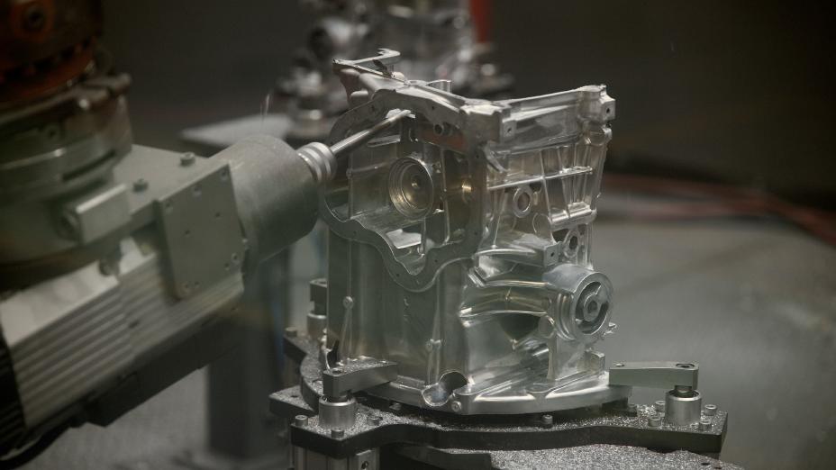 Close up image of a high-precision laser-guided robot making quality assurance checks on a high-pressure die cast at Nissan Casting plant Australia