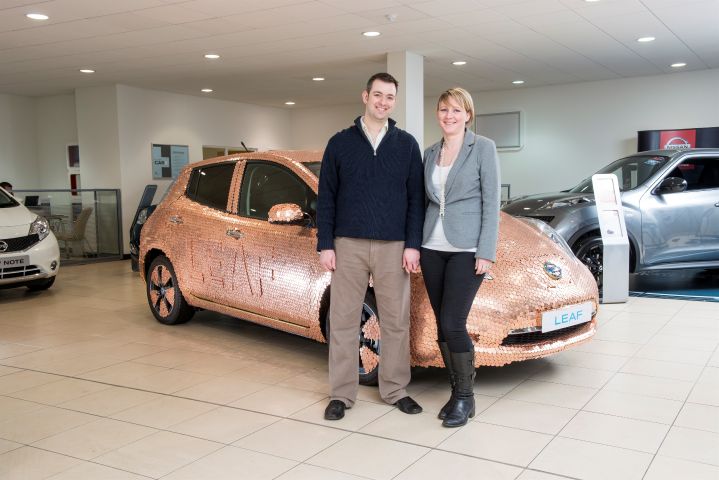 Brett Garner and his wife in front of copper plated Nissan LEAF
