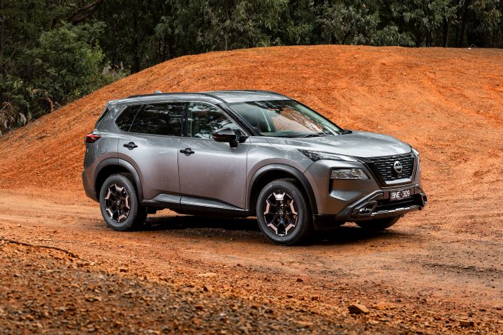 2024 Nissan X‑Trail N-Trek, static front ¾ exterior shot in orange dirt