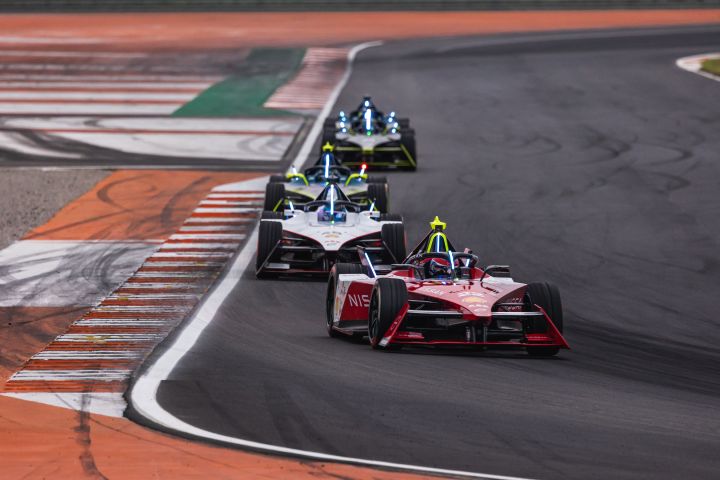 Quatre voitures de Formule E sur le circuit dirigées par un véhicule de Formule E Nissan