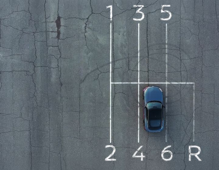 Aerial view of the 2027 Nissan Z NISMO MT parked in parking lanes resembling a gear shift pattern.