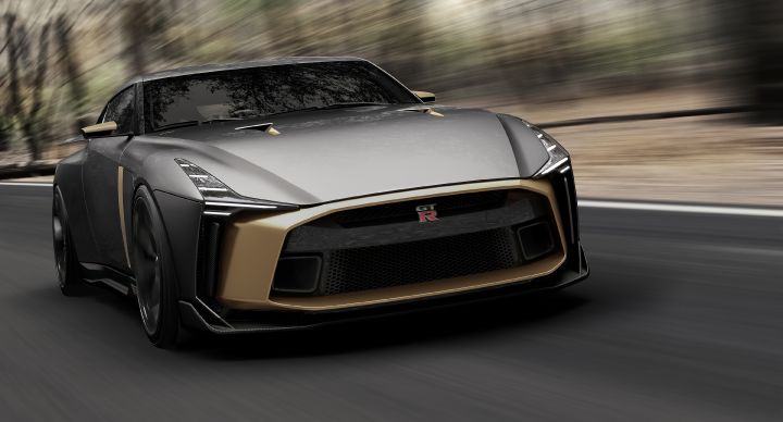 Front angled view of the Nissan GT-R50 by Italdesign driving down a street with speed.