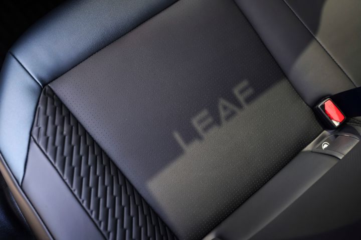 "LEAF" reflects via a shadow from the sunroof onto the seat portion of the passengers' seats inside the 2026 Nissan LEAF.