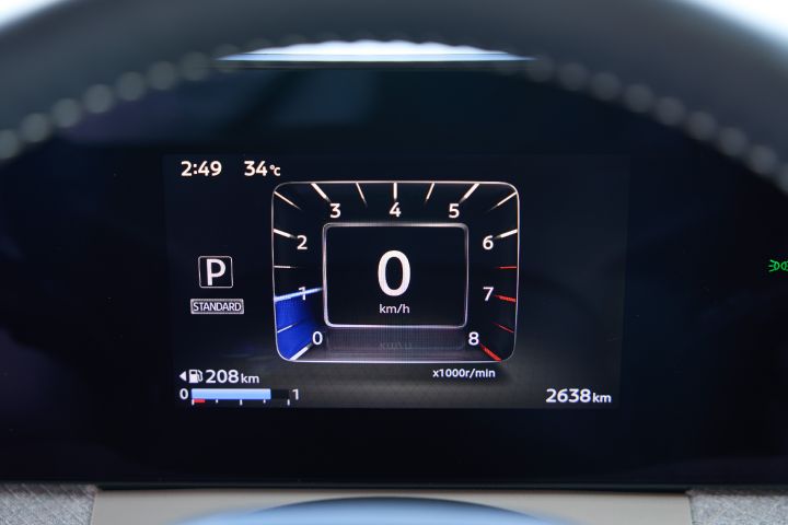 Digital meter cluster of the new Nissan Roox kei car. The center shows a speedometer reading 0 km/h, the left side displays "P" for parking mode and a fuel range of 208 km, and the bottom right shows an odometer reading of 2638 km. The background is dark, highlighting the brightness of the display.