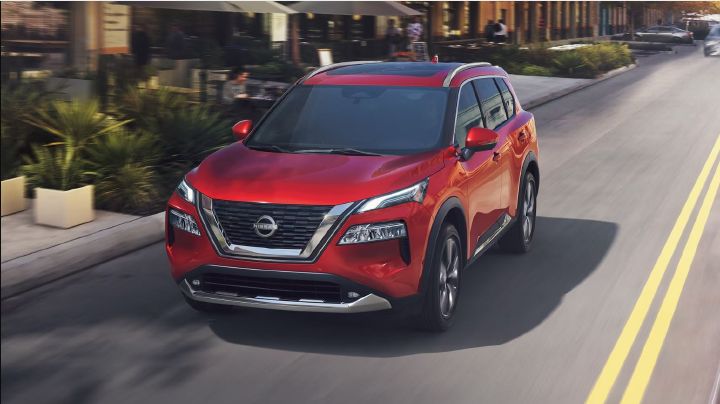 2023 Nissan Rogue driving down the road.