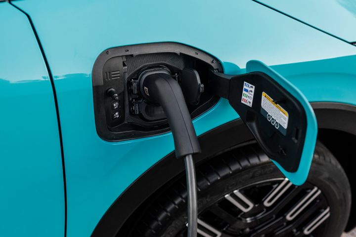 Nahaufnahme vom geöffneten Ladeanschluss an der Seite des Nissan LEAF mit eingestecktem Ladekabel