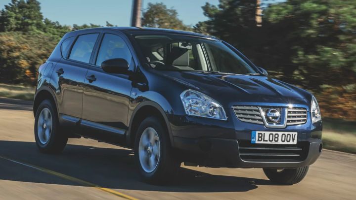 A black first generation Qashqai on a road